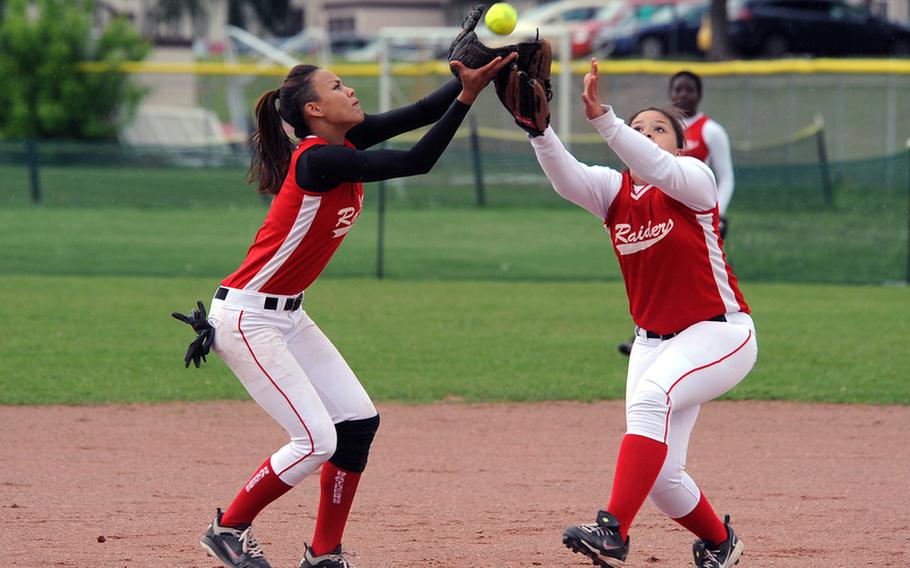 Kaiserslautern's Reagan McCurn, left, pulls in a fly ball in front of teammate Tia Hall.  Kaiserslautern beat Ramstein 1-0 in the first game of a home doubleheader to take the Western Region title.