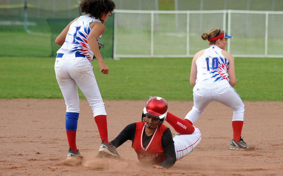 Kaiserslautern's Michelle Bonano slides safely into second as Ramstein's Cuba Cabiness, right, takes the throw from the outfield and Savannah Brooks covers the base. Bonano later crossed the plate for the winning run as Kaiserslautern beat their cross-town rivals 1-0, to take the Western Region title.