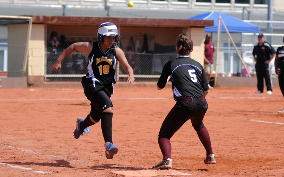 Patch's Caitlyn Steffen arrives at first base as Vilseck first baseman Taylor Hall is about to catch the ball during a game Saturday at Patch.