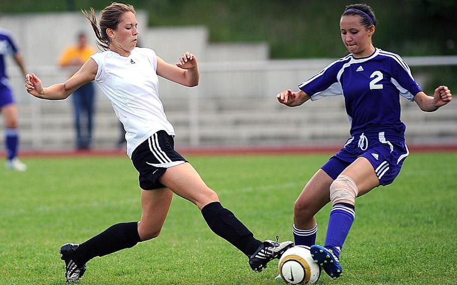 Morgan Dodge of Vicenza, left, and Bahrain's Stephanie Frerot fight for a ball in an opening day Division II game at the DODDS-Europe soccer championships in Waldmohr, Germany, Monday. Vicenza won the match.