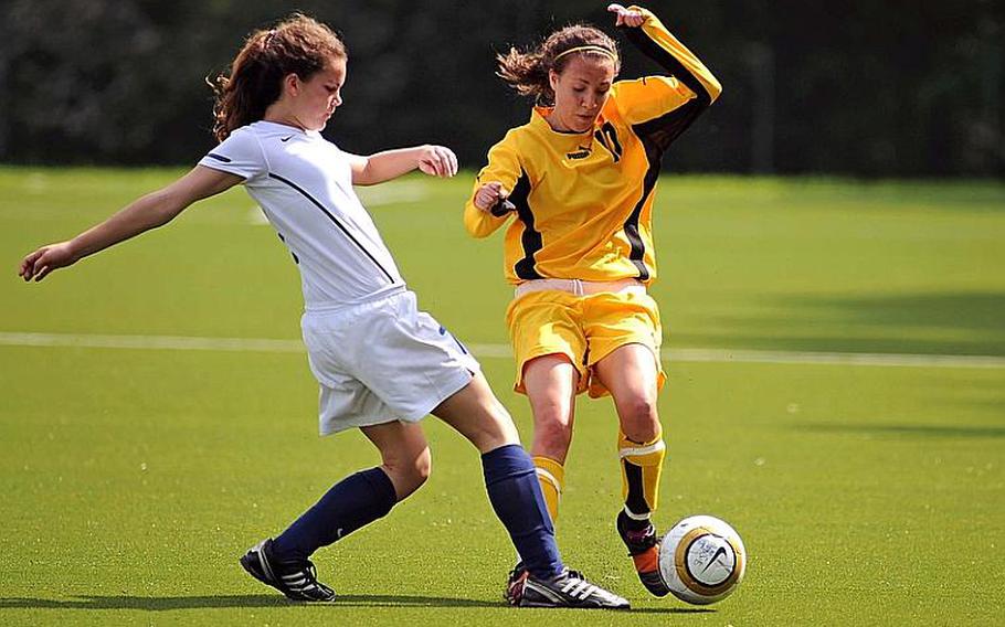ISB's Danielle White, left, clears the ball in front of Patch's Amanda Thaden in opening day Division I action at the DODDS-Europe soccer championships. The top-seeded Panthers beat ISB. 5-0.