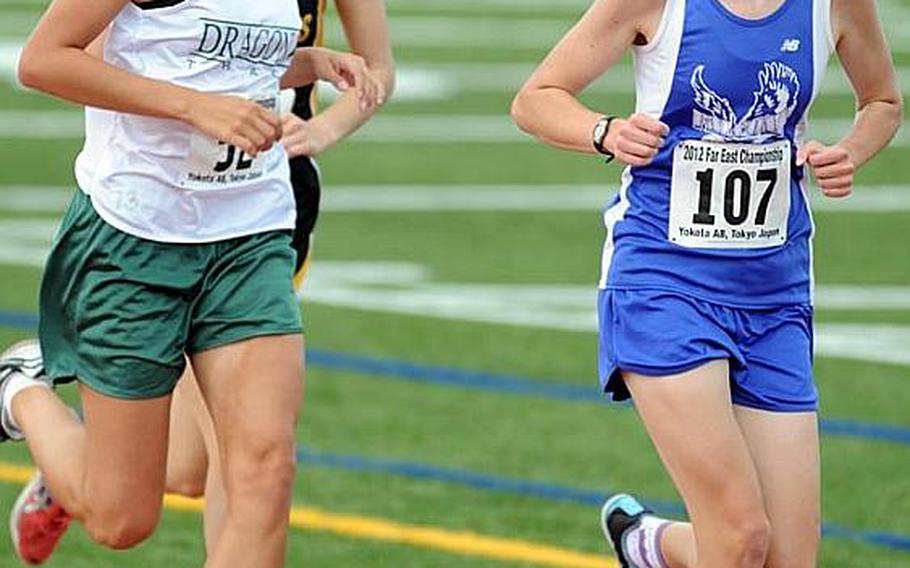 Two-time Far East cross-country champion Amanda Henderson, right, sets the pace for Michelle Stolle of American School In Japan and Allie Reichenberg of Kubasaki during Wednesday's girls 3,000 final in the Far East High School Track and Field Meet at Yokota Air Base, Japan. Henderson won in 11 minutes, 3.76 seconds, breaking the meet record of 11:12.7 set two years ago by ex-teammate Siarria Ingram.