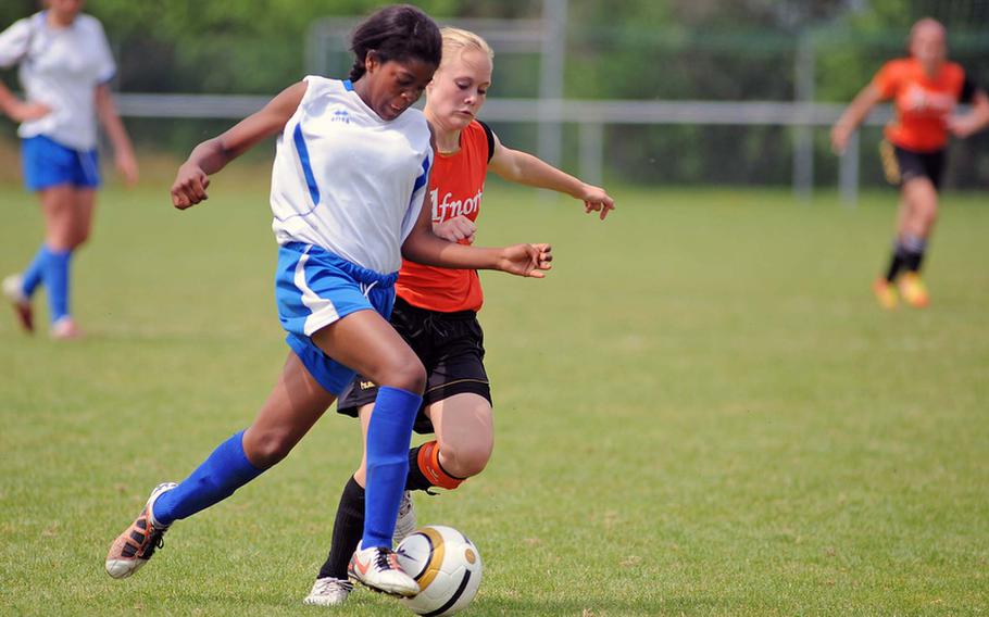 Marymount's Lori Nsimasi, left, and AFNORTH's Mackenzie Lynch battle for the ball in a Division II semifinal at the DODDS-Europe soccer championships. AFNORTH won the match 3-0.