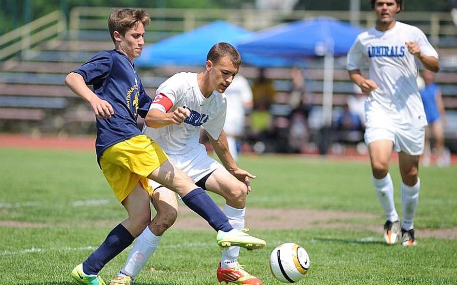 Florence's Giulio Pandolfi, left, toes the ball past Rota's Austin Hall and into the goal in Florence's 3-0 win over the Admirals in the boys Division III final at the DODDS-Europe soccer finals.