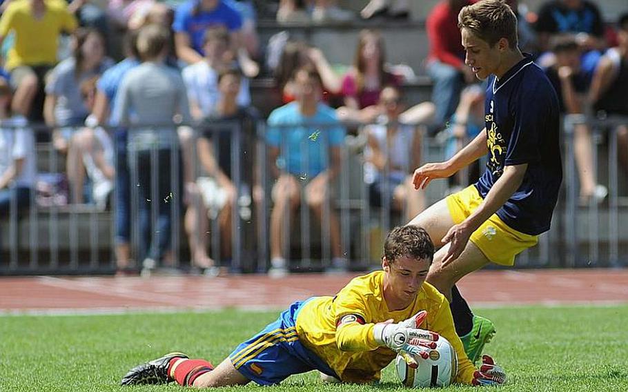 Rota keeper Keaton Regenor pulls in the ball ahead of a charging Giulio Pandolfi in the boys Division III final at the DODDS-Europe championships. Florence won 3-0 to take the crown.