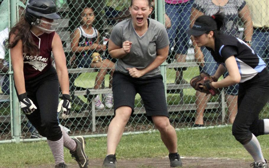 Zama American third-base coach Ana Rosa shouts encouragement to baserunner Nicole Oquendo, left, as Osan American third baseman Petrina Smith chases her down during Thursday's championship game in the Far East High School Girls Division II Softball Tournament at Naval Air Facility Atsugi, Japan. Zama beat Osan 27-10 for its first D-II title in any girls sport.