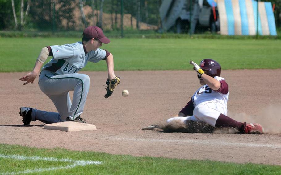 AFNORTH third-baseman Saverio Young is unable to field the ball as Baumholder's Zach Buhrer slides in safely during the DODDS-Europe baseball championships Thursday at Ramstein Air Base. Baumholder won 7-4.
