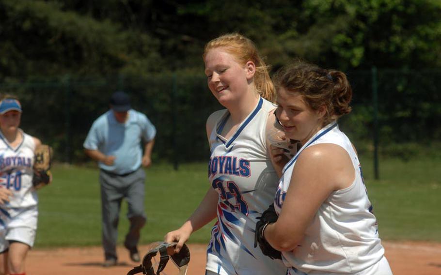 Katherine Enyeart is congratulated between innings during Ramstein High School's 12-1 win over Lakenheath in Thursday's opening pool play at the European high school softball championships. The tourney, played at Ramstein and Kaiserslautern high schools, runs through Saturday.