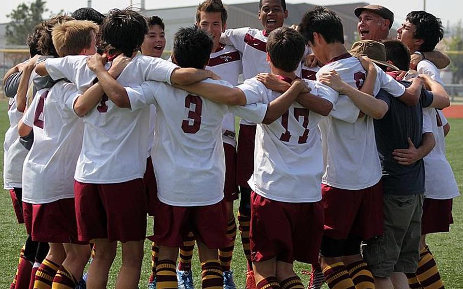 Matthew C. Perry Samurai boys soccer players enjoy the moments following their penalty-kick shootout victory over 2011 champion Yongsan International-Seoul in Friday's Far East High School Division I Tournament at Camp Humphreys, South Korea. The Samurai won their second title in three years, beating the Guardians 2-1 by outkicking them in the PK shootout 4-3.