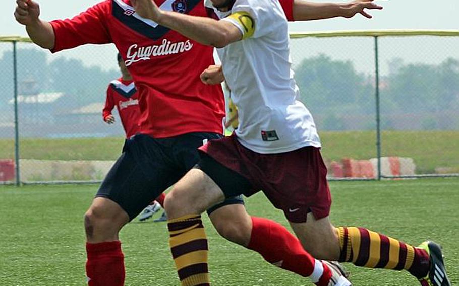 Matthew C. Perry's Tyelor Apple, right, and Yongsan International-Seoul's Allen Shin battle for the ball during  Friday's championship match in the Far East High School Division I Tournament at Camp Humphreys, South Korea. The Samurai won their second title in three years, dethroning the Guardians 2-1 by outkicking them in the PK shootout 4-3.