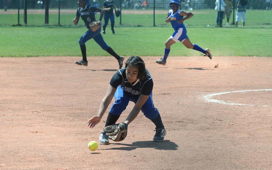 Incirlik pitcher Megan Morales fields a bunt as her teammate, Danaisha Tate, runs to cover third base ahead of Sigonella base runner Kiana Jones during the second day of action in the DODDS-Europe softball championship from Ramstein Air Base in Germany. Incirlik won 18-2.