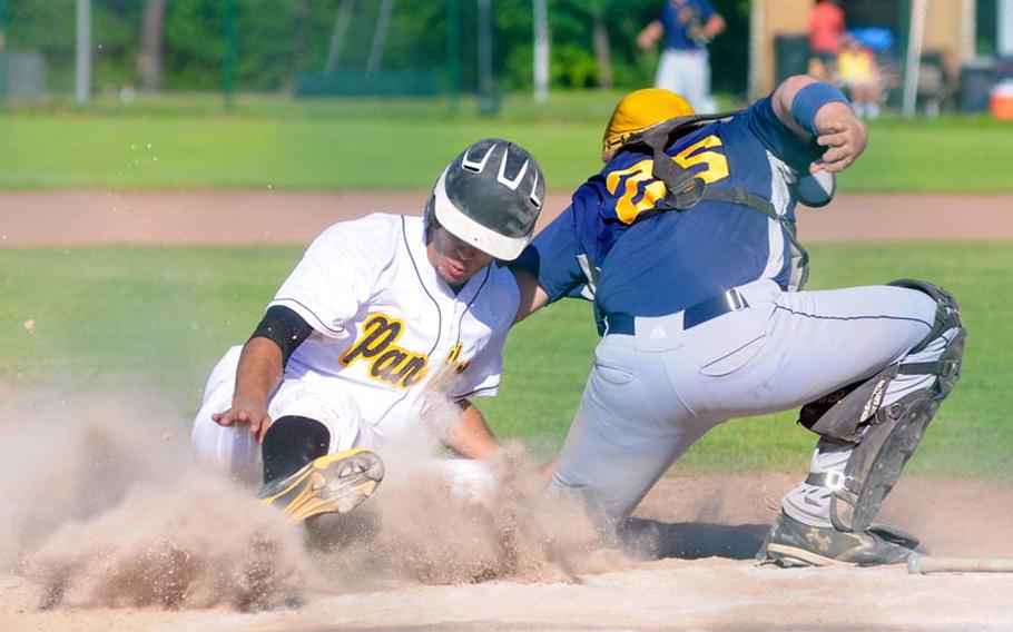Patch's Ruben Rodriquez safely slides home as Heidelberg's catcher Caelan Allmon attmepts to tag him out during a Division I semifinal game of the DODDS European baseball championships.