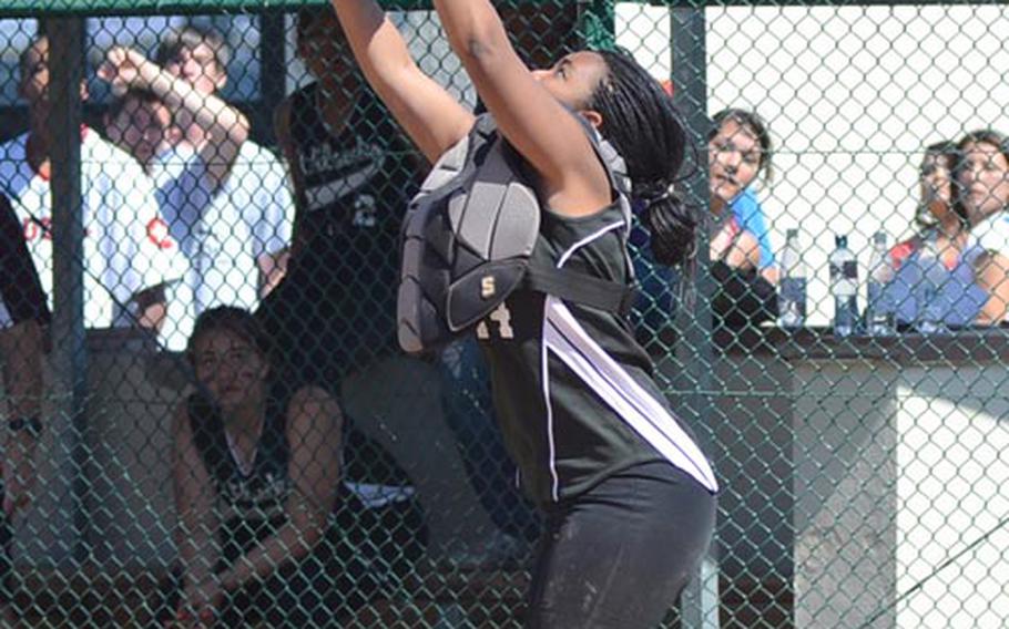 Vilseck catcher Ashton Wiggins catches a popup for an out during the Division I championship softball game Saturday against Ramstein. The Royals won 9-5.