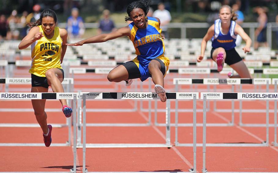 Wiesbaden's Phylecia Faublas, center, won the 100-meter hurdles in 16.36 seconds. Second was Abigail Diaz, left, and Bitburg's Brettina Thomas was third. At right is Ansbach's Jennifer Strosnider, who finished sixth.