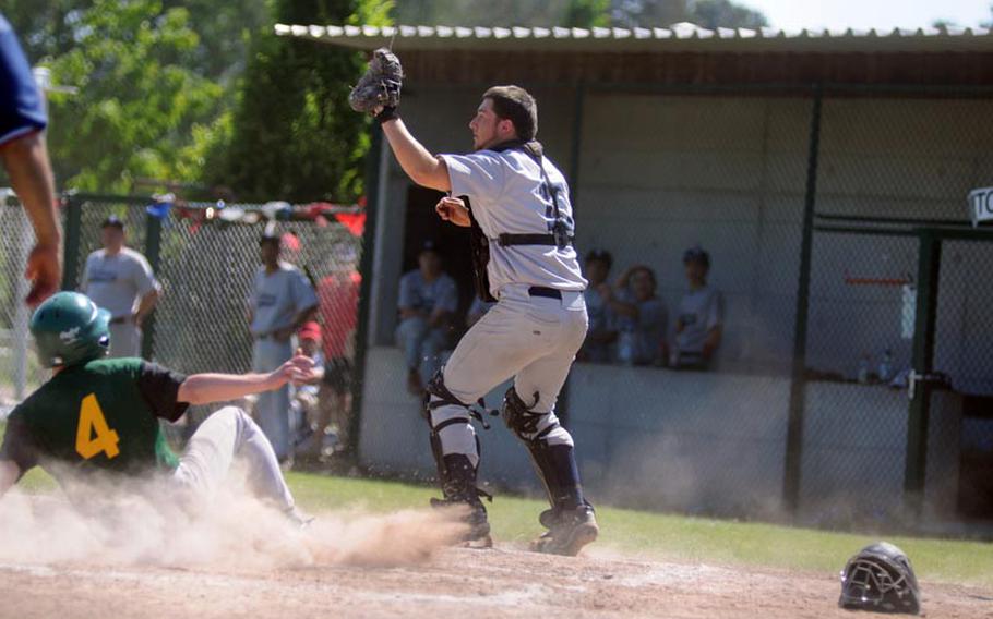 SHAPE's Austin Collazzo safely slides into home as Bitburg's Zach Nichols catches the ball away from home plate during the European Division II/III championships Saturday.