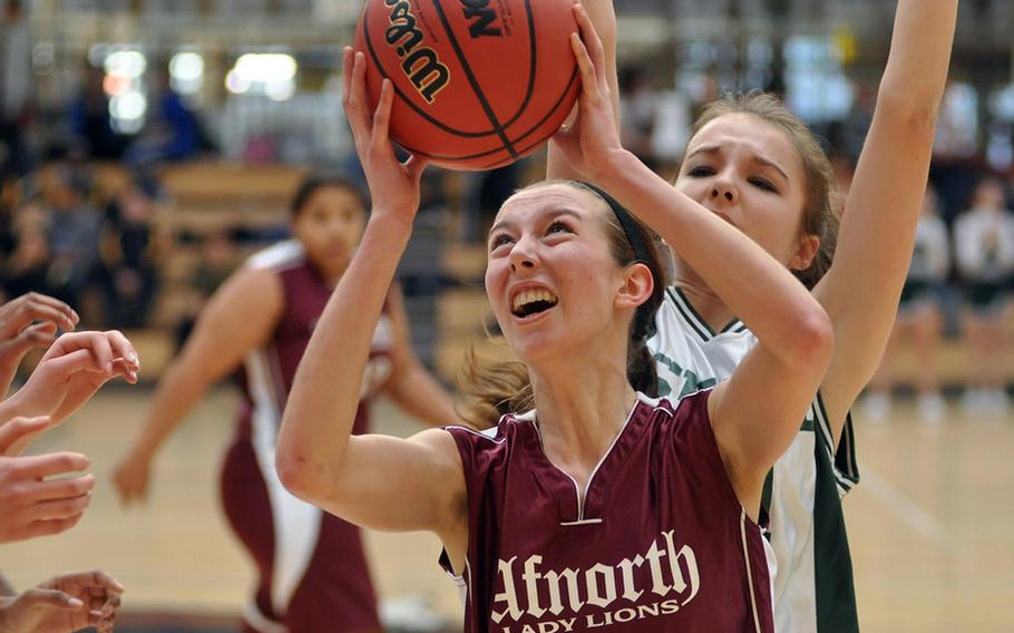 AFNORT's Sara Sawyer grabs a rebound and then prepares for a shot Saturday during the Division II final at the DODDS-Europe basketball championships in February. Sawyer, a senior, has been named the DODDS-Europe female Athlete of the year.