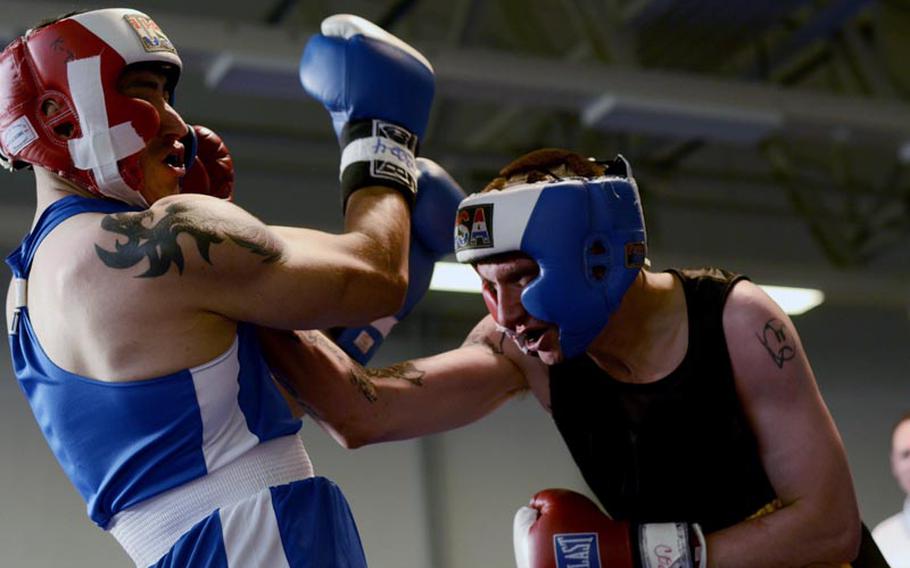 Chance Claxton, left, takes an uppercut from Luis Trevino in their middleweight bout Saturday night during the Installation Management Command Boxing Invitational at Miesau Army Depot, Germany.