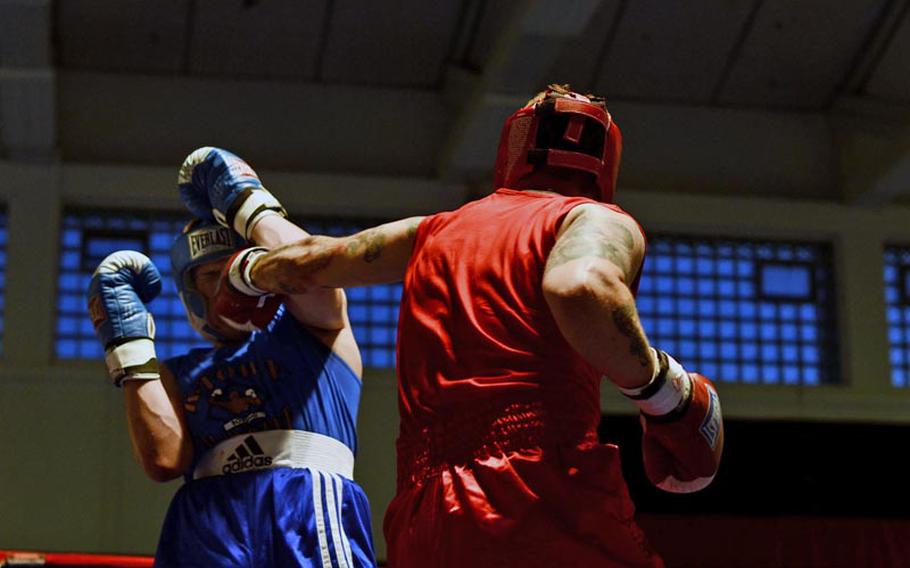 Brett Lambert connects with a left against Christian Keene in their heavyweight bout Saturday night during the Installation Management Command Boxing Invitational at Miesau Army Depot, Germany.