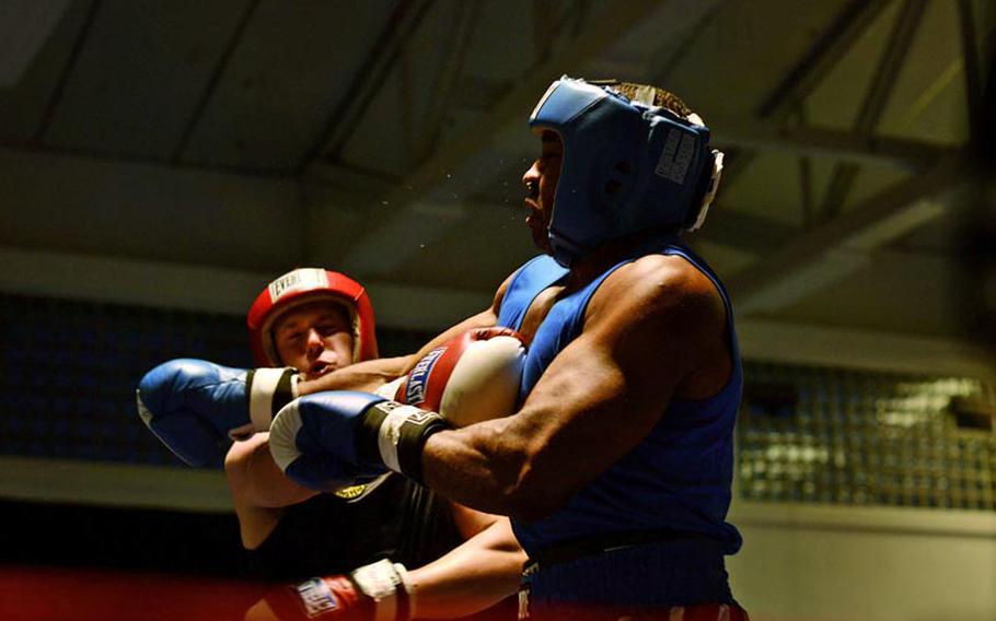 Nicholos Heinen, left, and Anthony Santiago exchange blows in their super heavyweight bout Saturday night during the Installation Management Command Boxing Invitational at Miesau Army Depot, Germany.