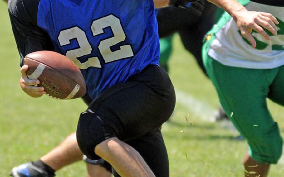 Kadena Dragons quarterback Matthew Fuller looks for running room against the Camp Hansen Wolfpack defense during Saturday's U.S. Forces Japan-American Football League South Division regular-season finale at Camp Hansen, Okinawa. The Wolfpack rallied from an 8-2 deficit to beat the Dragons 24-8.