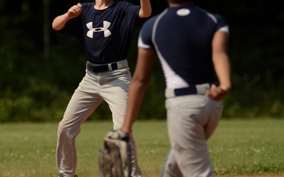 Ethan Vincent, second baseman for the 11-12 year-old All-Stars, waits for the ball thrown from shortstop Jared Mendiola in Thursday's practice at Ramstein Air Base, Germany.
