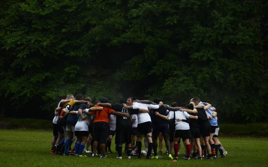 The Ramstein Rogues rugby team huddles before a recent practice at Ramstein Air Base.