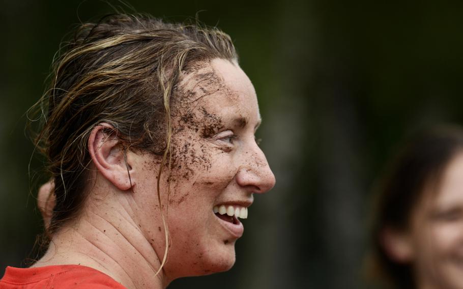 Danielle Goulet-Carpenter, a former performer on the Canadian national women's team, gets an ear full of mud during a rainy rugby practice at Ramstein Air Base.