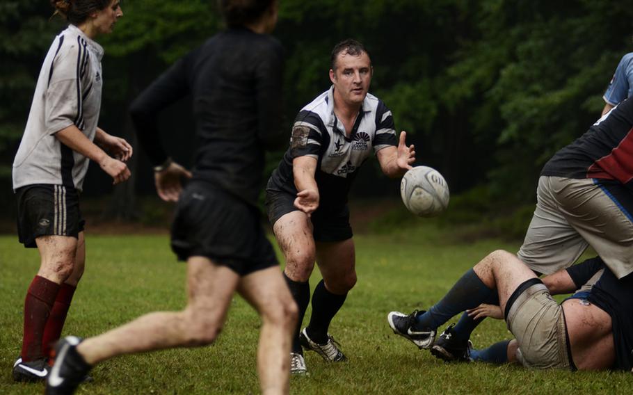 Clive "Frenchy" French, a flight sergeant with the British Royal Air Force and team coach for the Ramstein Rogues, passes the ball to a women's squad team member during a practice at Ramstein Air Base.