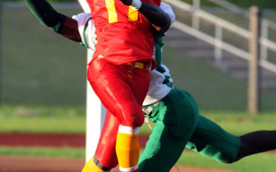Camp Foster Bulldogs receiver Justin Garrard pulls in a pass in front of Camp Hansen Wolfpack defender Travis Killing during Saturday's U.S. Forces Japan-American Football League South Division championship game at Camp Foster, Okinawa. The defending champion Bulldogs blanked the Wolfpack 32-0 to advance to their third Torii Bowl league title game in four years.