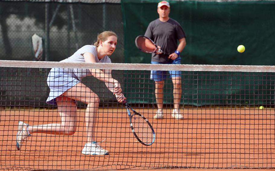 Alison Spain returns a shot in the mixed doubles finals of the U.S. Forces-Europe tennis finals in Heidelberg, Germany, Saturday, as partner Brett Freedman watches. The Ramstein pair defeated Heidelberg's Nate Strong and Sally Cotter 6-2, 6-0 to take the title. Spain and Freedman also took the women's and men's open titles respectively on Friday.