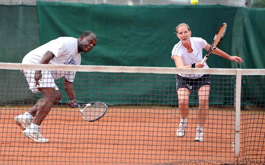 Nate Strong and Sally Cotter watch the ball sail over the net in the mixed doubles finals of the U.S. Forces-Europe tennis finals in Heidelberg, Germany, Saturday. The Heidelberg pair fell to Landstuhl's Brett Freedman and Alison Spain 6-2, 6-0.