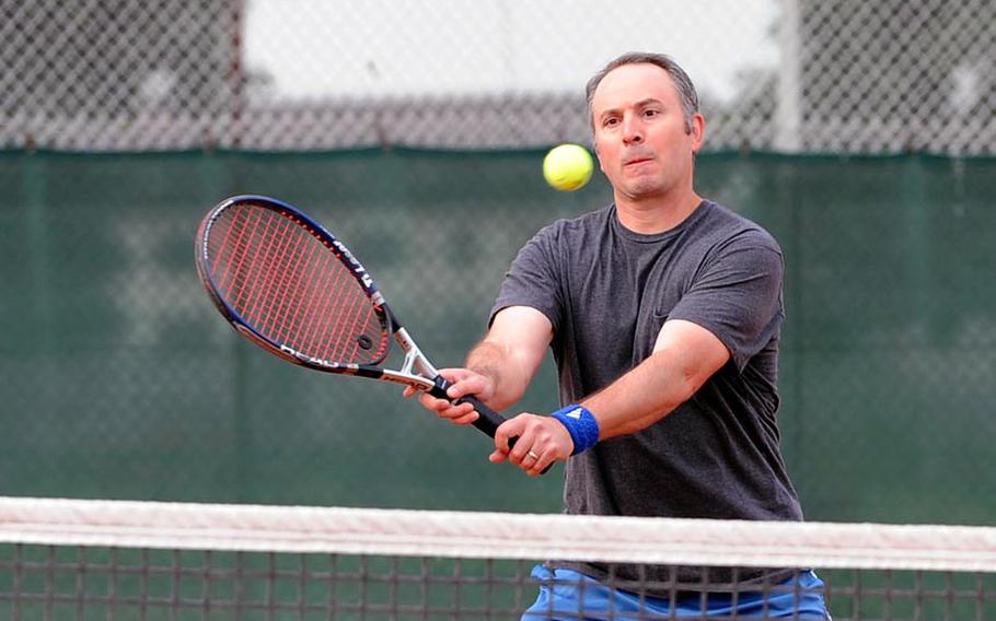 Brett Freedman returns a ball in mixed doubles finals of the U.S. Forces-Europe tennis finals in Heidelberg, Germany, Saturday. Freedman and partner Alison Spain defeated Nate Strong and Sally Cotter 6-2, 6-0 to take the title. Spain and Freedman also took the women's and men's open titles respectively on Friday.