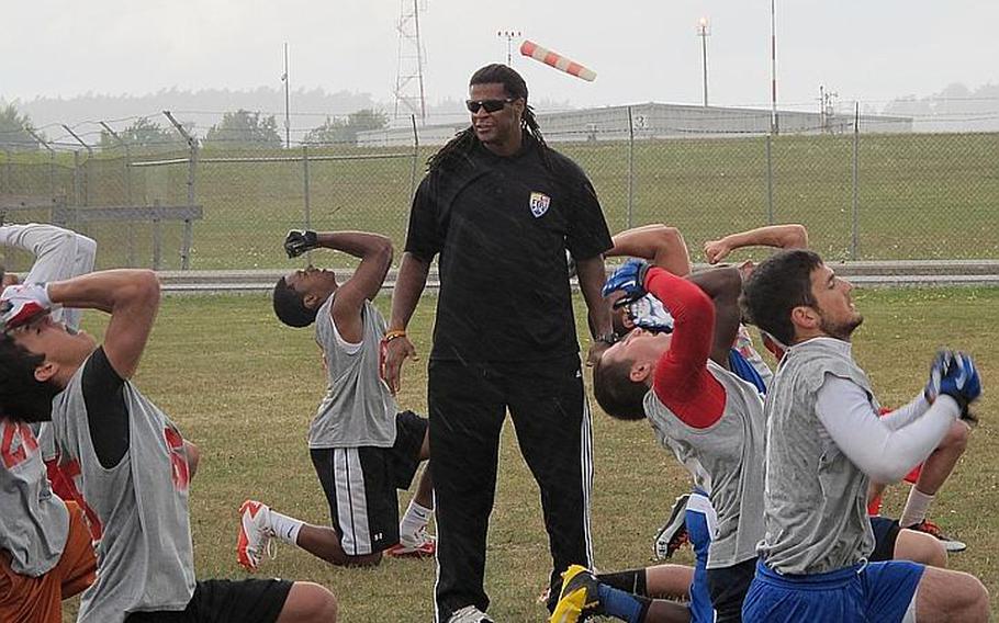 Football University staffer and Sky Sports commentator Cecil Martin, a former Philadelphia Eagles fullback, guides players through a tackling drill Sunday at Ansbach, Germany.