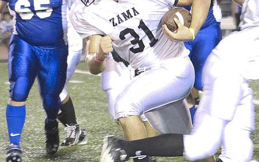 Zama American running back Andre Encarnacion splits the Yokota Panthers defense during Friday's DODDS Japan-Kanto Plain Association of Secondary Schools football game at Yokota Air Base, Japan. Yokota won 50-0.