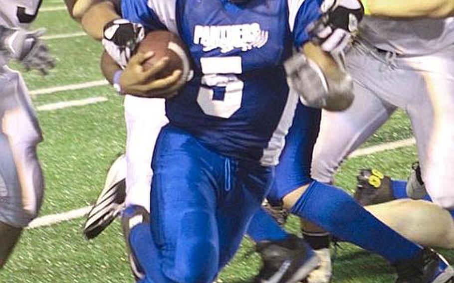 Yokota running back Kalik Battle seeks running room against the Zama American defense during Friday's DODDS Japan-Kanto Plain Association of Secondary Schools football game at Yokota Air Base, Japan. Yokota won 50-0.