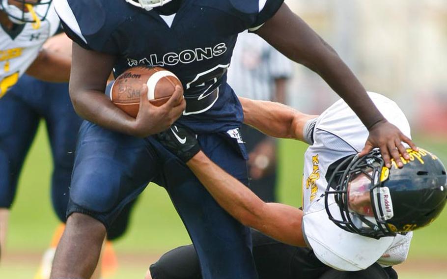 Seoul American running back Brandon Roseborough tries to shed the tackle of Kadena Panthers defender Justin Sego during Saturday's DODDS Pacific Division I regular-season game at Camp Foster, Okinawa. The Panthers blanked the Falcons 35-0.