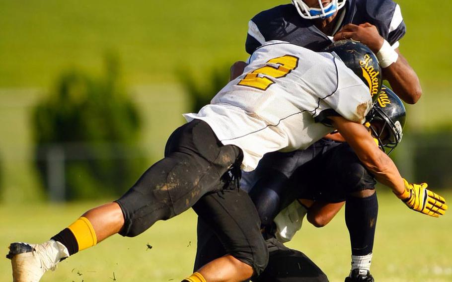 Kadena Panthers defender Joey Dyer slams into Seoul American Falcons ballcarrier Ronald Dogan during Saturday's DODDS Pacific Division I regular-season game at Camp Foster, Okinawa. The Panthers blanked the Falcons 35-0.