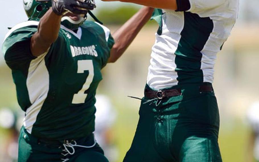 Daegu receiver Caleb Page snags a touchdown pass away from Kubasaki defender Jamal Ellis during Saturday's DODDS Pacific inter-district, inter-division football game at Camp Foster, Okinawa. The Dragons routed the Warriors 39-8.