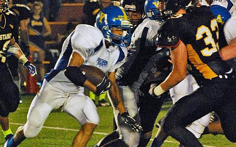 Yokota Panthers running back Morgan Breazell takes a handoff late in the first quarter as American School In Japan's Henry Wallrapp draws a bead on him during Friday's Kanto Plain Association of Secondary Schools football game at American School In Japan's Chofu campus in western Tokyo.