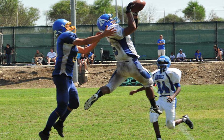 Rota's Ramon Quijano, who scored three touchdowns on offense, intercepts a pass Saturday in the Admirals' 42-0 victory over Sigonella in the first game of the DODDS-Europe football season. Rota, the defending Division III champion, won its eighth straight contest.