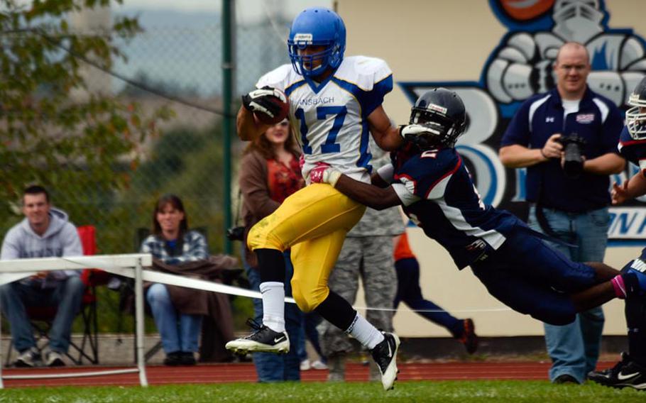 Ansbach's Xavier Cage is taken down by Bitgurg's CJ Evans in the second half of Bitburg's 50-36 win over Ansbach.