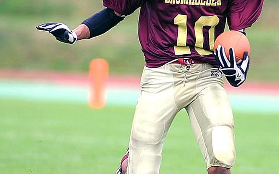 Baumholder's Ben McDaniels keeps his eyes on an opponent as he rushes upfield in a game against Sigonella earlier this season.