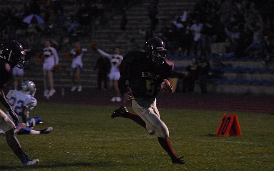 Baumholder senior Ben Holliday runs for a touchdown on Friday during his team's homecoming game against Brussels. The Bucs went on to win the game, 57-6.