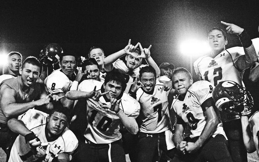 Guam High football players Lorden Aguon (7), Mark Ecija (8), Cabe Robit (9), Daniel Morta (10), Josh Foronda (12), Tegan Brown (16) and Cody Burpo (32) celebrate following Saturday's inter-district high school football game at Camp Foster, Okinawa. Guam High beat the host Kubasaki Dragons 28-12, the Panthers' first win over a DODDS school in nine tries.