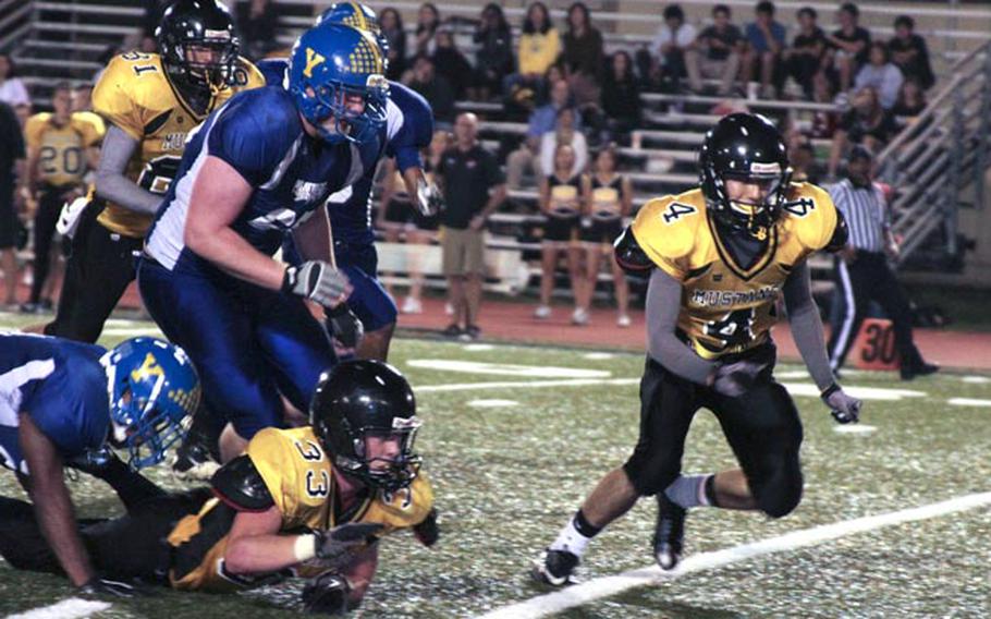 American School In Japan 's Drogin James leads the chase for a fumble against the Yokota Panthers during Friday's Kanto Plain Association of Secondary Schools football game at Yokota Air Base, Japan. Yokota won 42-7, sweeping the season series from ASIJ for the first time since 2007.