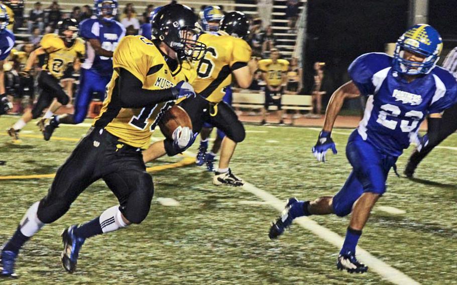 American School In Japan running back Haru Kent skirts right end as Yokota defender Morgan Breazell gives chase during Friday's Kanto Plain Association of Secondary Schools football game at Yokota Air Base, Japan. Yokota won 42-7, sweeping the season series from ASIJ for the first time since 2007.