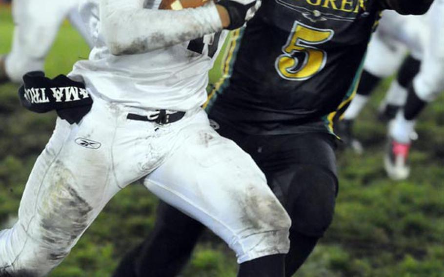 Zama American senior tailback Mitchell Harrison skirts right and and gets chased by Robert D. Edgren defender Khalil Williams during Friday's Far East Division II football game at Misawa Air Base, Japan. 