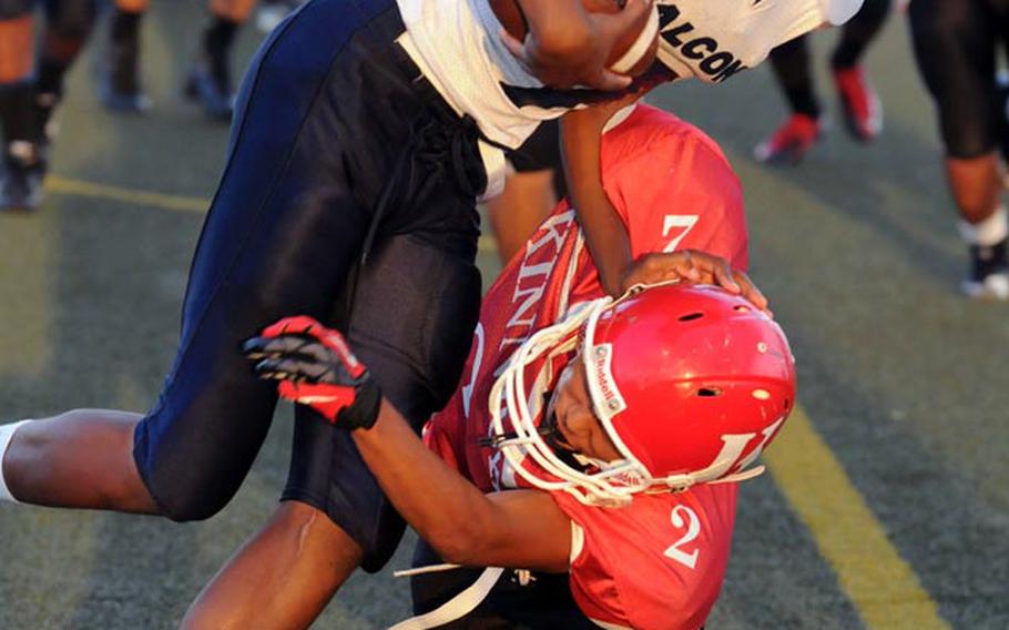 Seoul American receiver Desmond Patton gets tackled by Nile C. Kinnick's Marvin Newbins during Saturday's Far East Division I football game at Yokosuka Naval Base, Japan.