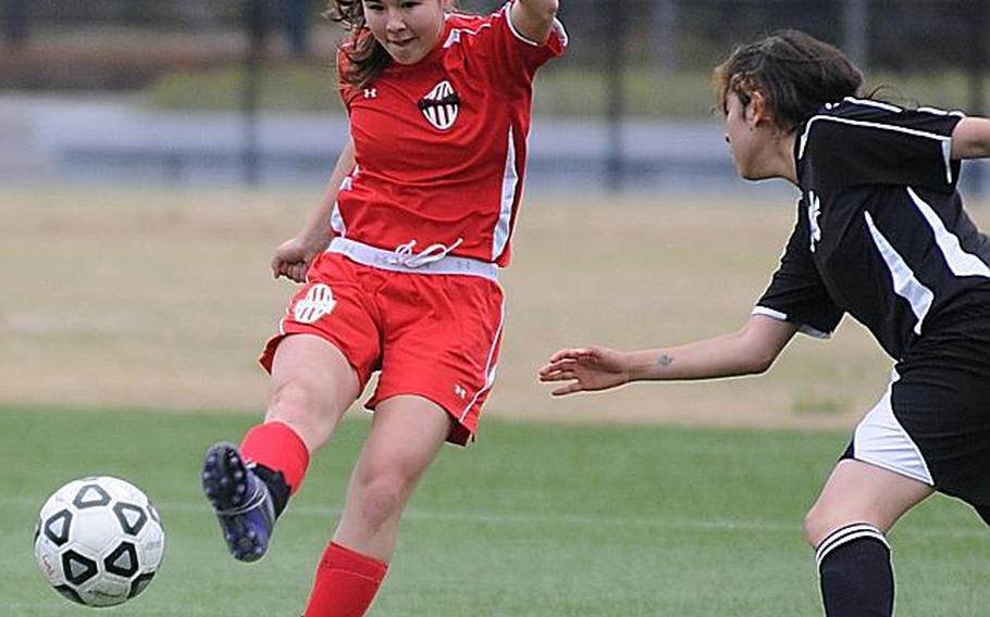 Nile C. Kinnick striker Kaile Johnson boots the ball past a Matthew C. Perry Samurai defender during a match last season, when she led the Pacific with 35 goals.