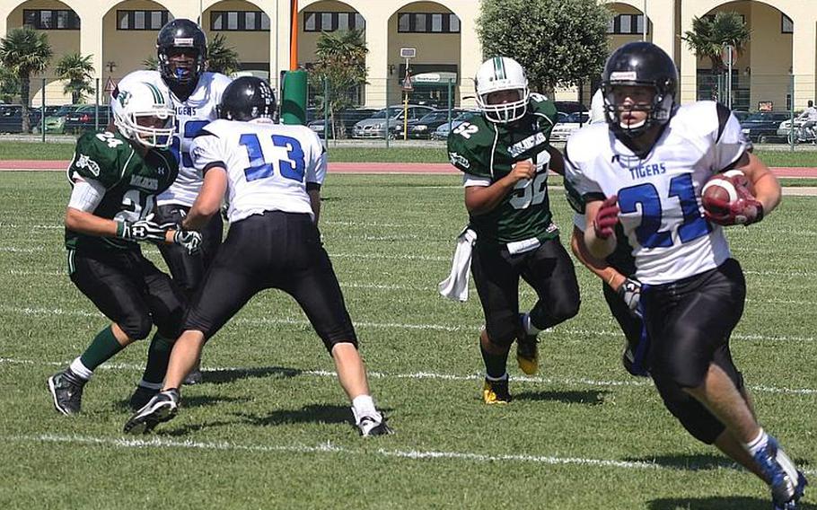 Hohfenfels sophomore David Vidovic turns the corner Sept. 15 in Naples as linebacker Makua Camarao gives chase and Hohenfels' Kyle Zeltner walls off defensive back Tyler Williams The play underscores the postgame comment of Naples coach Steve Altstiel: "(Vidovic) broke a few outside, and once he was in the open field it was difficult to catch him."